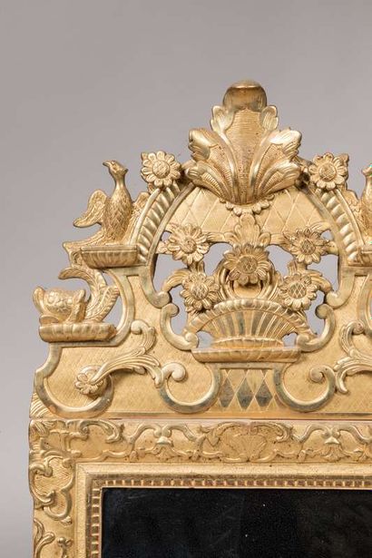 Gilded and carved wood mirror adorned with...