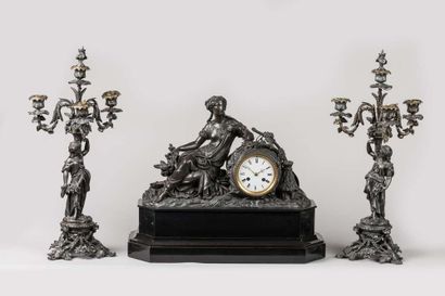 Black mantel set with a clock representing...