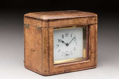 Brass travel clock in its leather case,
Ht...