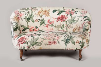 Sofa of corbeille form, front legs on casters,...