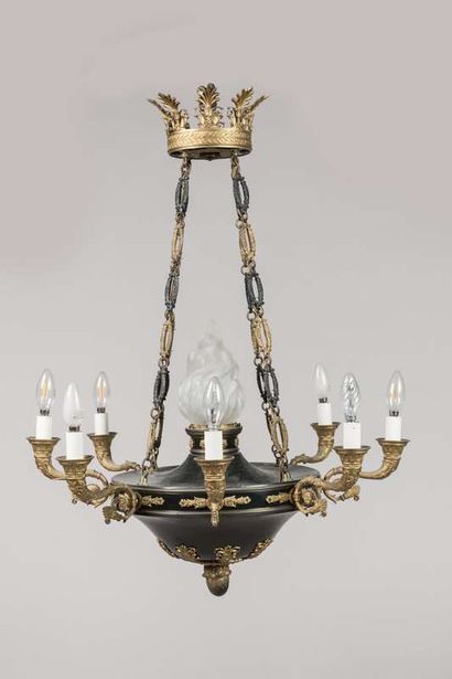 A brass and sheet metal chandelier with a...