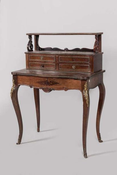 Desk in rosewood and rosewood veneer. It...