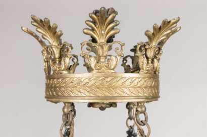 A brass and sheet metal chandelier with a...