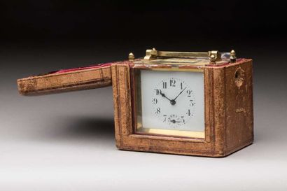 Brass travel clock in its leather case,
Ht...