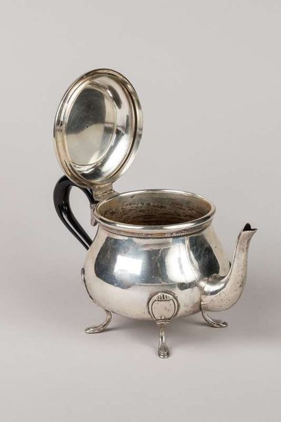Round baluster coffee pot in silver resting...