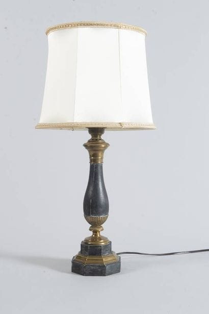 Lampe en tôle patinée et bronze. Le fût en...