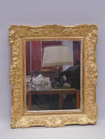Mirror in a carved and gilded wood frame....