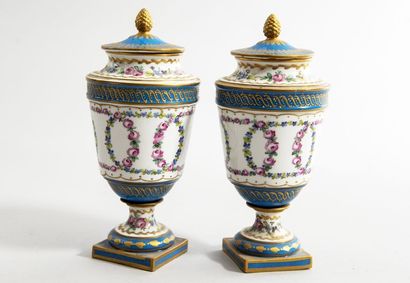 Pair of small covered vases on pedestal in...
