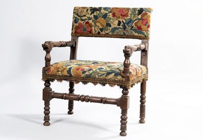 Walnut armchair, the ends of the arms carved...