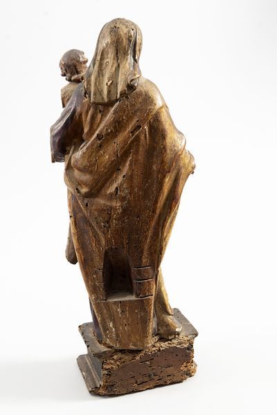 On a pedestal, a carved and gilded Virgin...