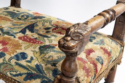 Walnut armchair, the ends of the arms carved...