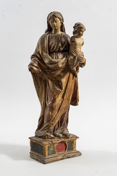 On a pedestal, a carved and gilded Virgin...