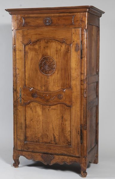 Bonnetière in cherry wood, the door carved...