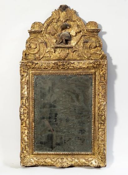 Mirror in a gilded and carved wood frame,...