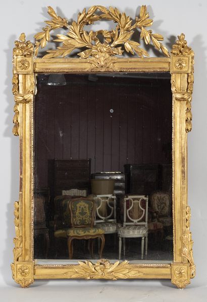 Mirror in a gilded wood frame with laurel...