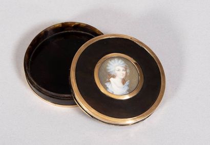 Circular brown tortoiseshell box with mobile...