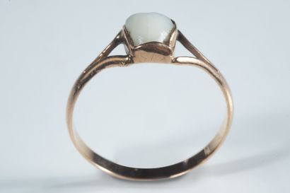 Small ring adorned with a milk tooth on yellow...