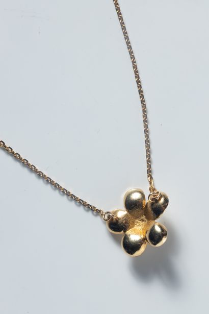 Collier ras de cou supportant une fleur épanouie...