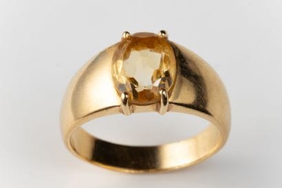 Ring set with an oval faceted citrine in...