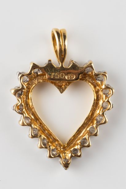 Heart pendant set with a border of diamonds...