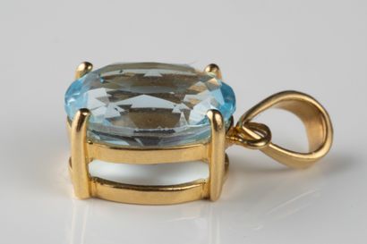 Pendant adorned with an oval faceted topaz...