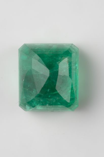 A rectangular cut emerald on paper weighing...