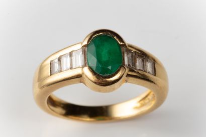 Half-moon ring set with an oval faceted emerald...