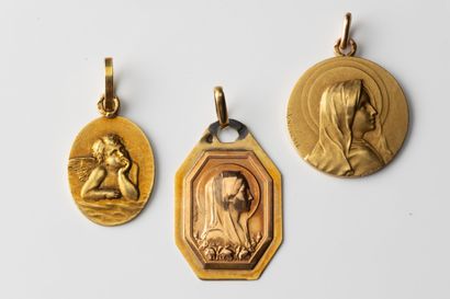 3 religious medals, 2 of a virgin and one...