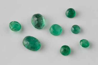 Lot of round and one oval emeralds on paper...