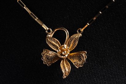 Necklace centered on a filigree orchid in...