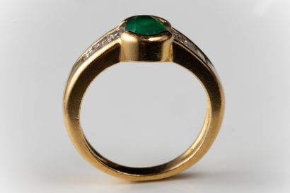 Half-moon ring set with an oval faceted emerald...