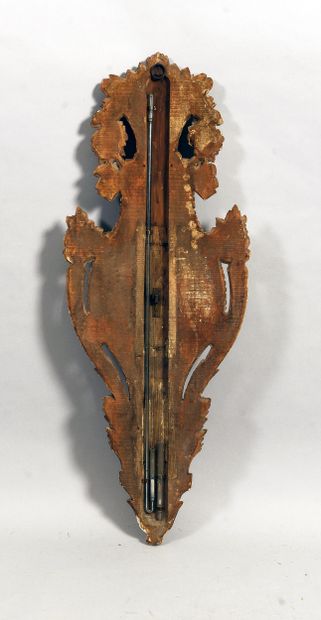 Carved and gilded wood barometer adorned...
