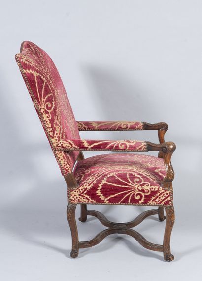Carved wooden armchair, sheepskin bone armrests...