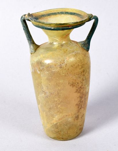 Bottle flanked by two handles. Cylindrical...