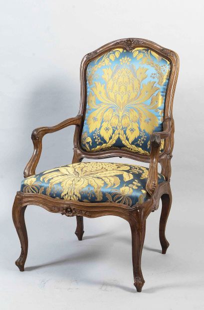 Moulded and carved wooden armchair with queen
and...