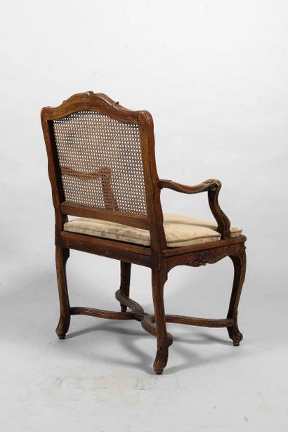 Queen-shaped caned armchair in walnut, molded...