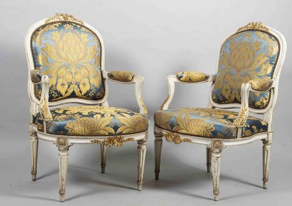Pair of molded, carved, cream and gold relacquered...