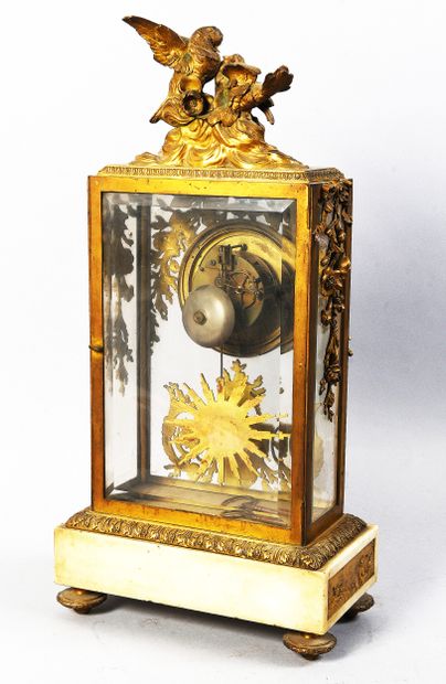 Gilt bronze cage clock on marble base decorated...