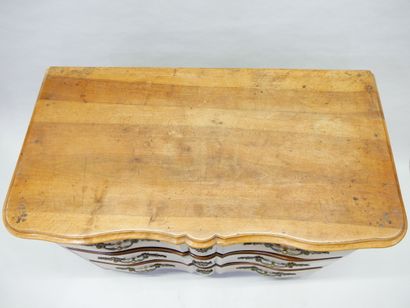 * Natural wood crossbow-front chest of drawers...