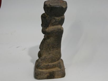 Stone sculpture with crusty patina depicting...
