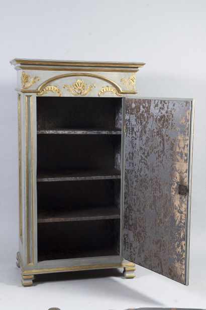 Small carved wood cupboard opening by a door,...