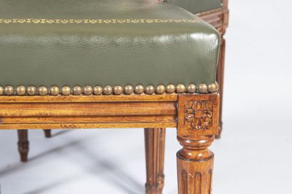 Six Louis XVI style molded wood chairs resting...