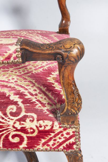 Carved wooden armchair, sheepskin bone armrests...