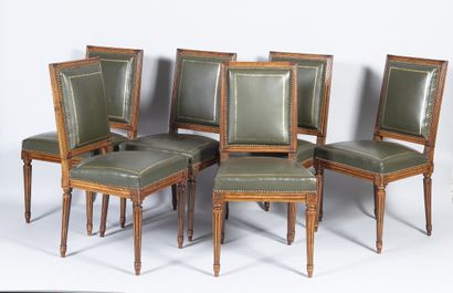 Six Louis XVI style molded wood chairs resting...
