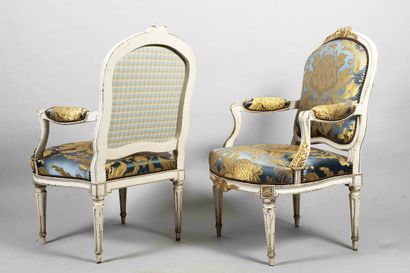 Pair of molded, carved, cream and gold relacquered...