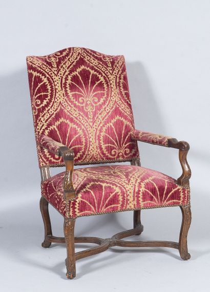Carved wooden armchair, sheepskin bone armrests...