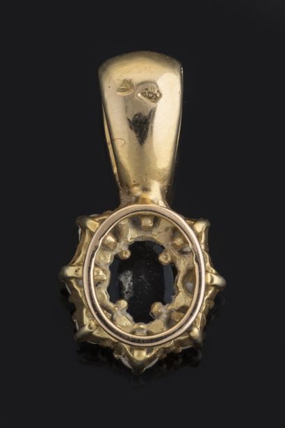 Daisy pendant centered on an oval sapphire...