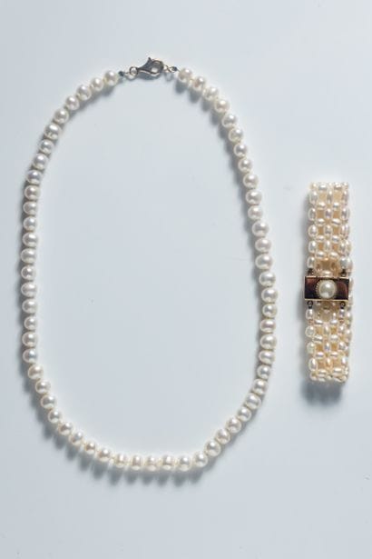 Two pieces of jewelry adorned with white...