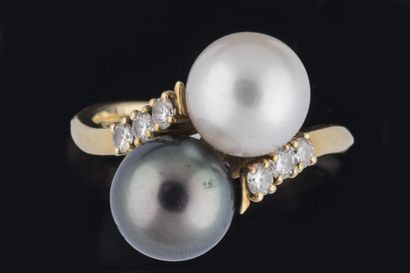 Ring set with two cultured pearls, one white...
