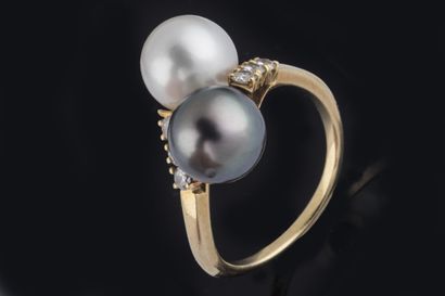 Ring set with two cultured pearls, one white...